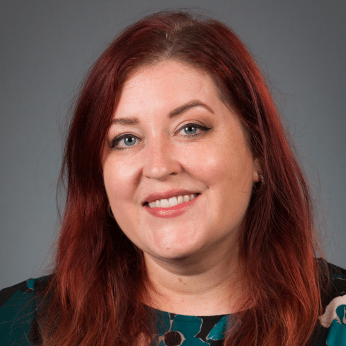 women with long reddish hair smiling in a headshot