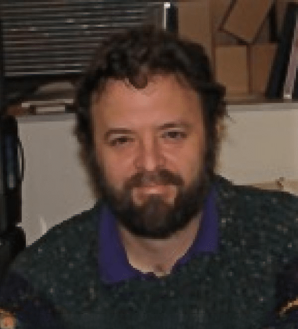 Headshot of man with dark brown hair and facial hair